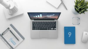 Modern flat-lay of a desk with a laptop displaying an SEO dashboard and website analytics, symbolizing digital growth and professional web design for small businesses in Abuja.